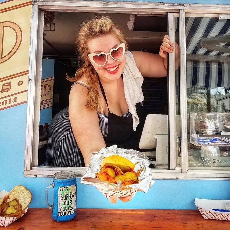 bee-food-truck Bee serving a chicken sandwich in the food truck