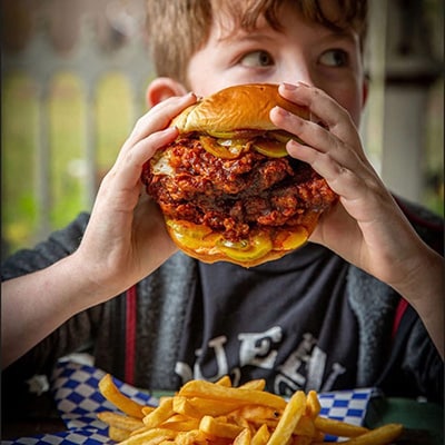 big-chicken-sandwich-kid Kid holding a big fried chicken sandwich